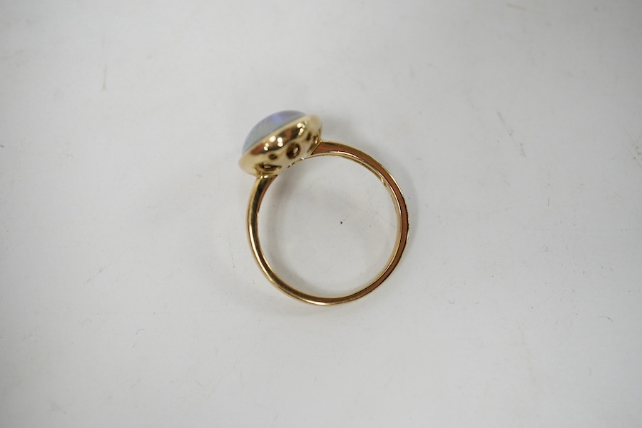 A modern 9ct gold and oval opal triplet set ring, size P/Q, gross weight 4 grams. Condition - good